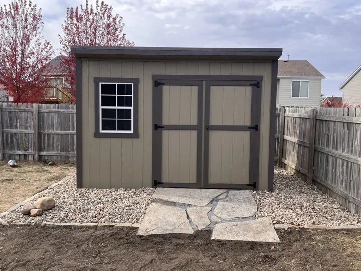 Tan Shed & Rock Landscaping